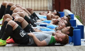 Australian Socceroos football players stretch during a team training run in Vitoria, Brazil on June 4, 2014, as they prepare for the 2014 FIFA World Cup in Brazil. AFP PHOTO/William WEST (Photo credit should read WILLIAM WEST/AFP/Getty Images)